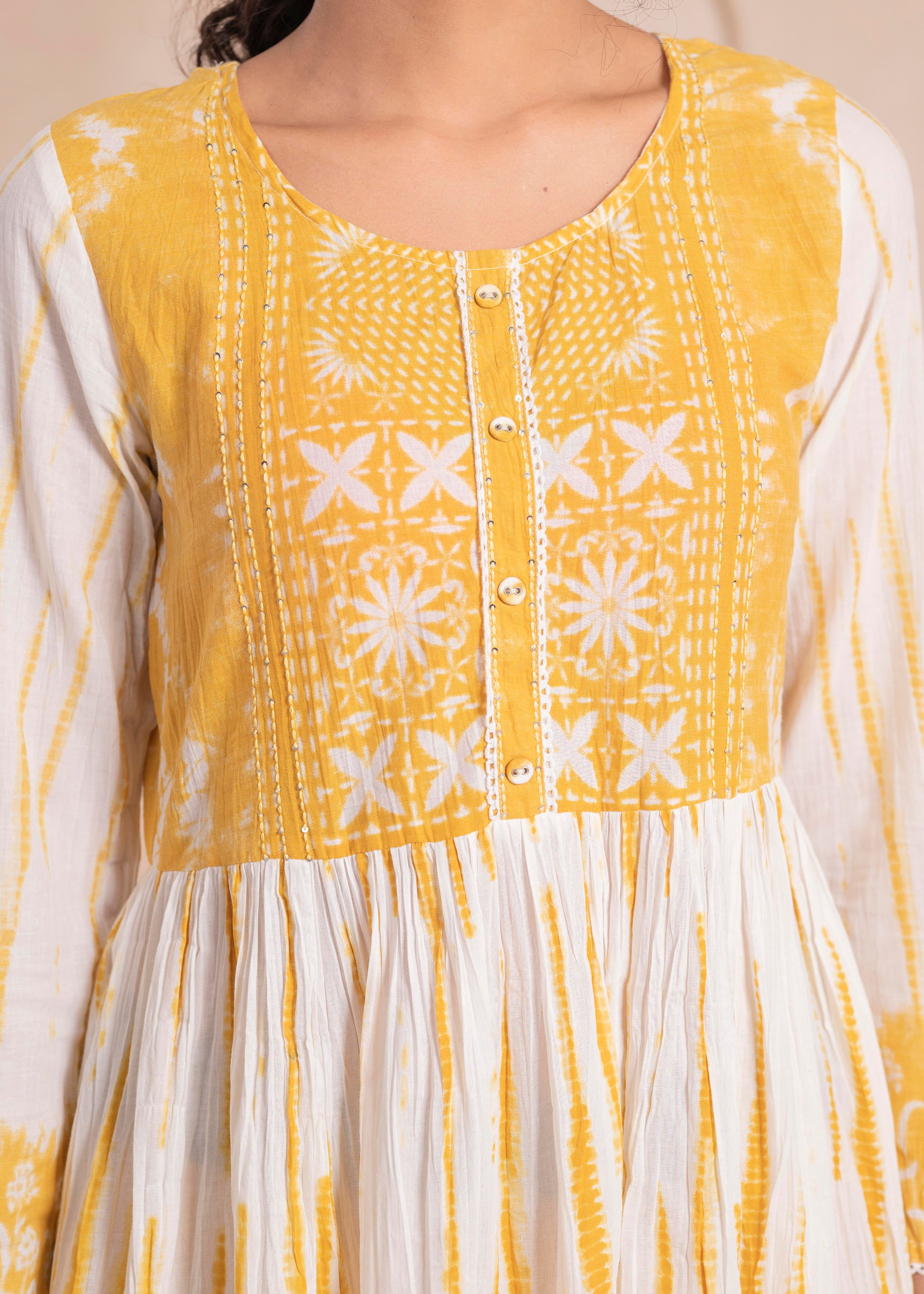 Mustarad and white kurta , solid bottom and tie - dye dupatta with cotton lace , buttons , sequince