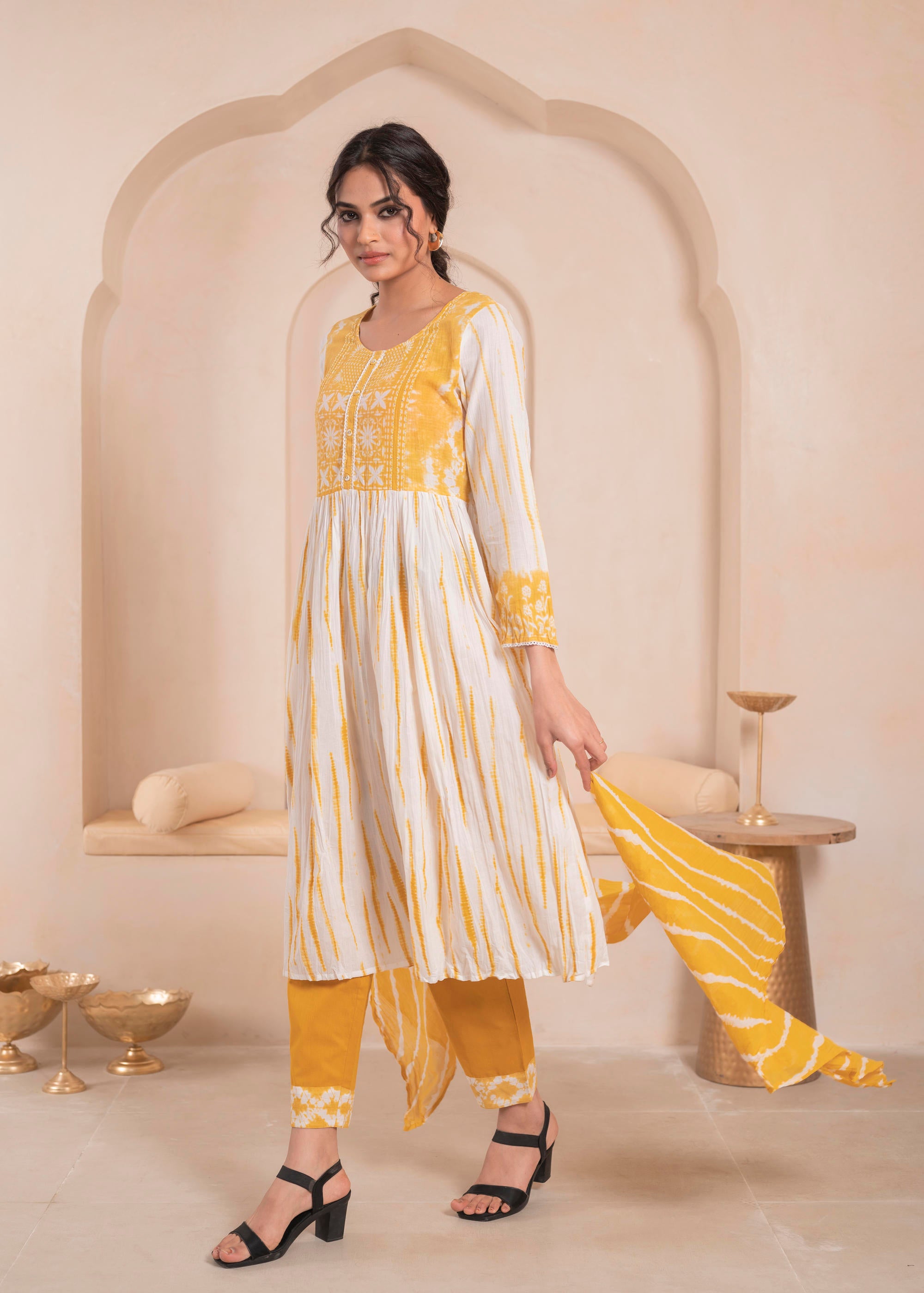 Mustarad and white kurta , solid bottom and tie - dye dupatta with cotton lace , buttons , sequince