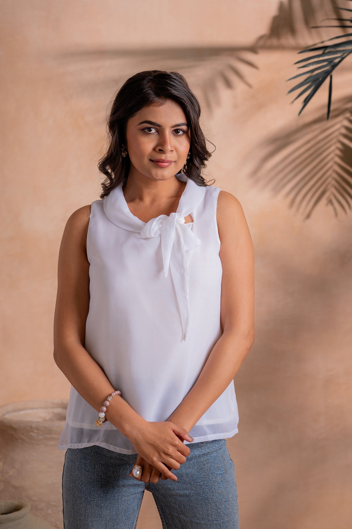 Lamora Elegant White Sleeveless Bow-Neck Layered Hem Top