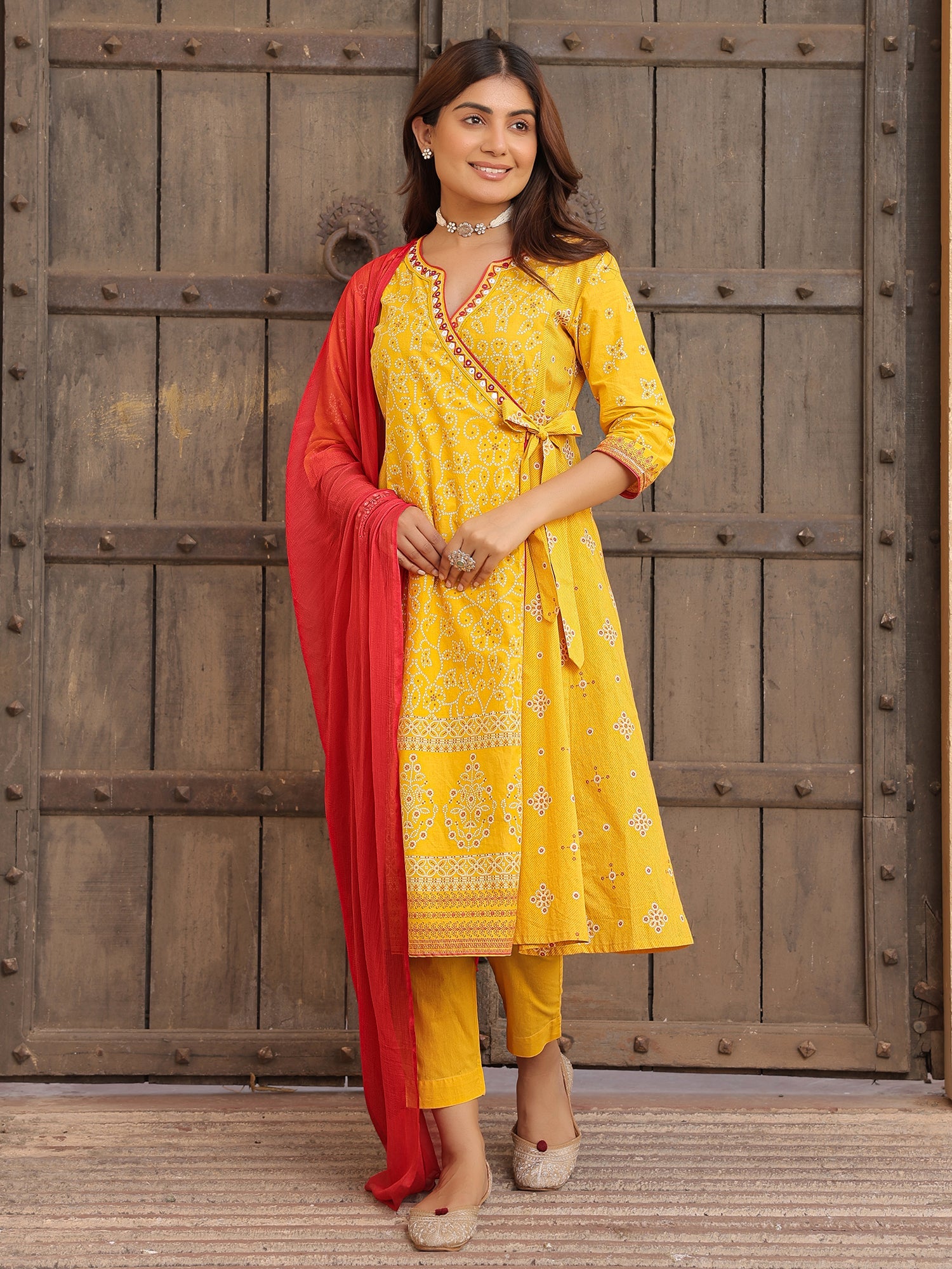 Juniper Mustard Bandhani Print Angrakha Cotton Kurta With Pants & Dupatta Set With Mirror Work Embroidery