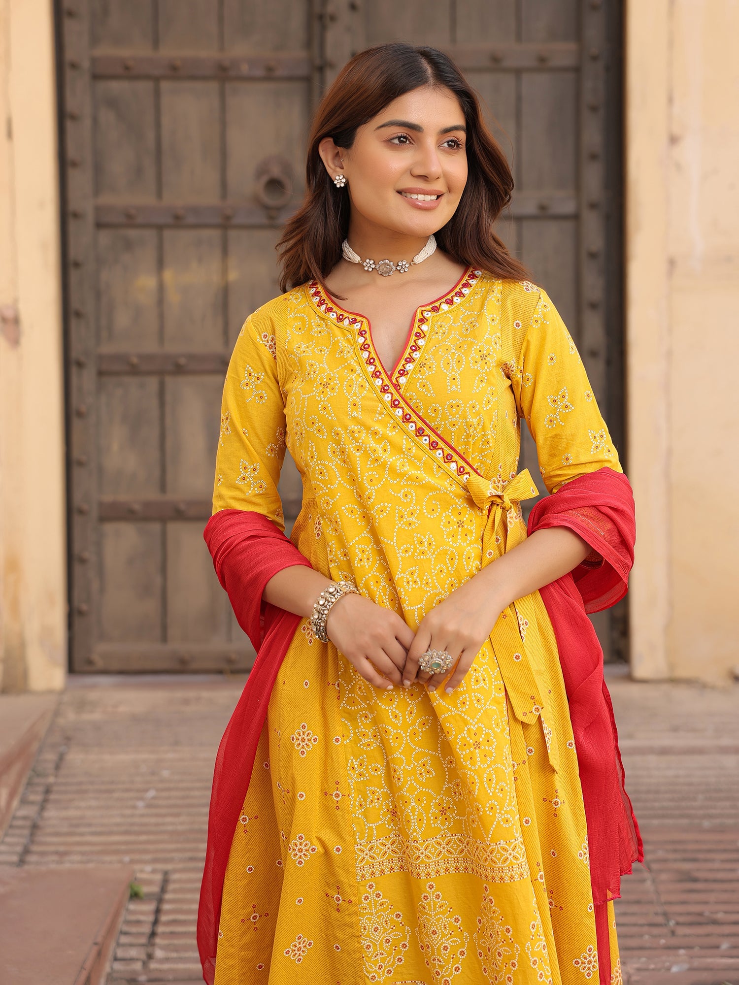 Juniper Mustard Bandhani Print Angrakha Cotton Kurta With Pants & Dupatta Set With Mirror Work Embroidery