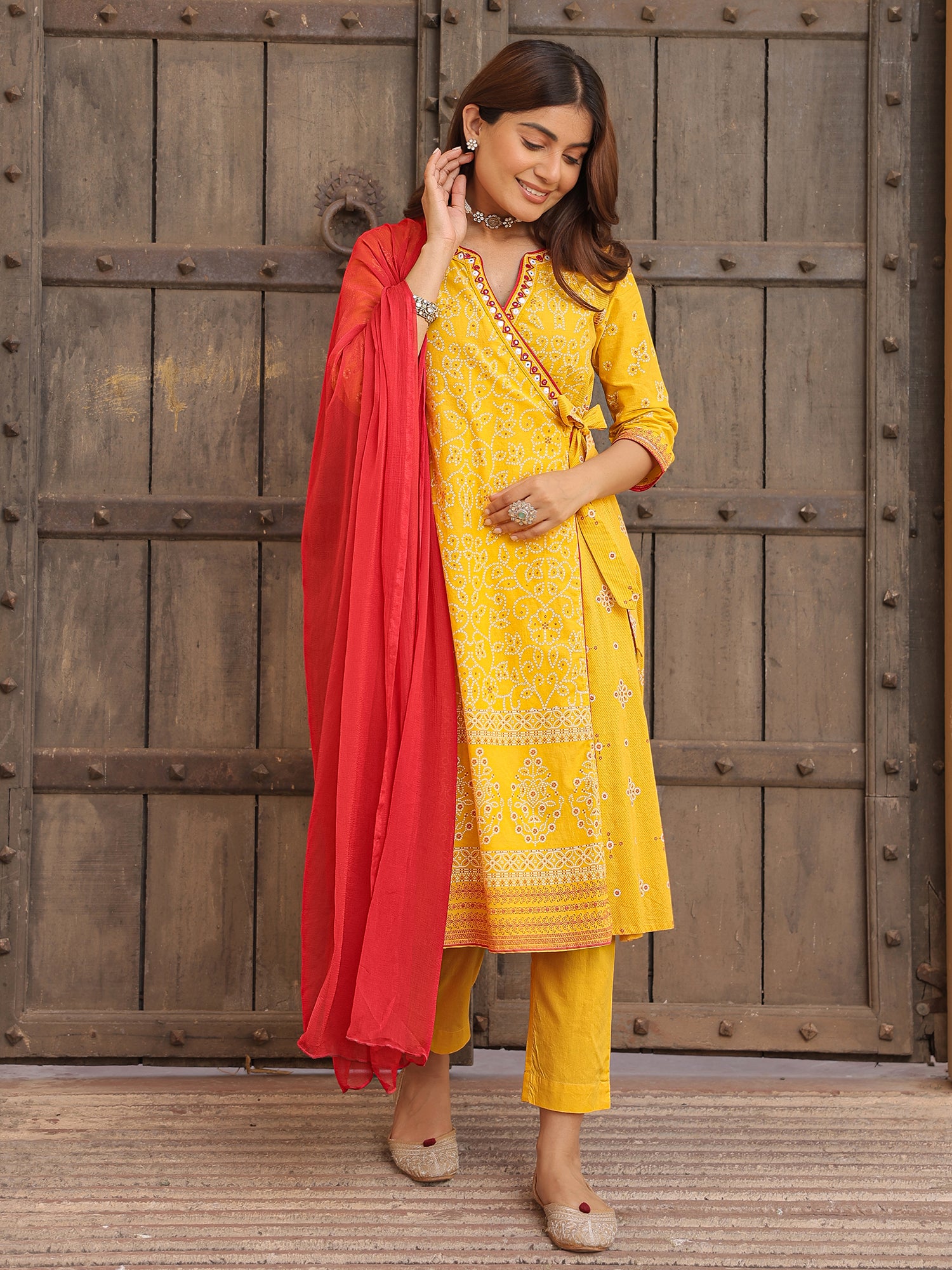 Juniper Mustard Bandhani Print Angrakha Cotton Kurta With Pants & Dupatta Set With Mirror Work Embroidery
